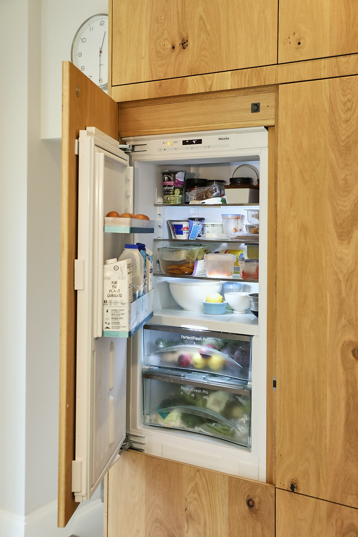 Integrated Miele fridge in oak cabinets