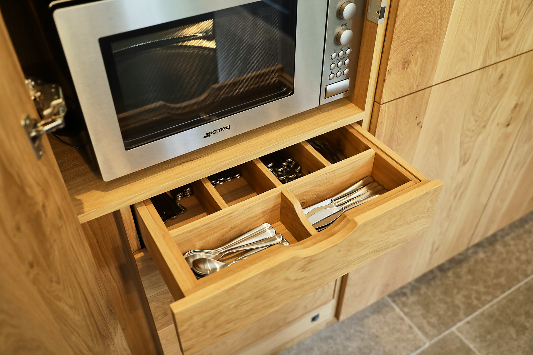 Solid oak cutlery insert in tall kitchen cabinets separates knives and spoons