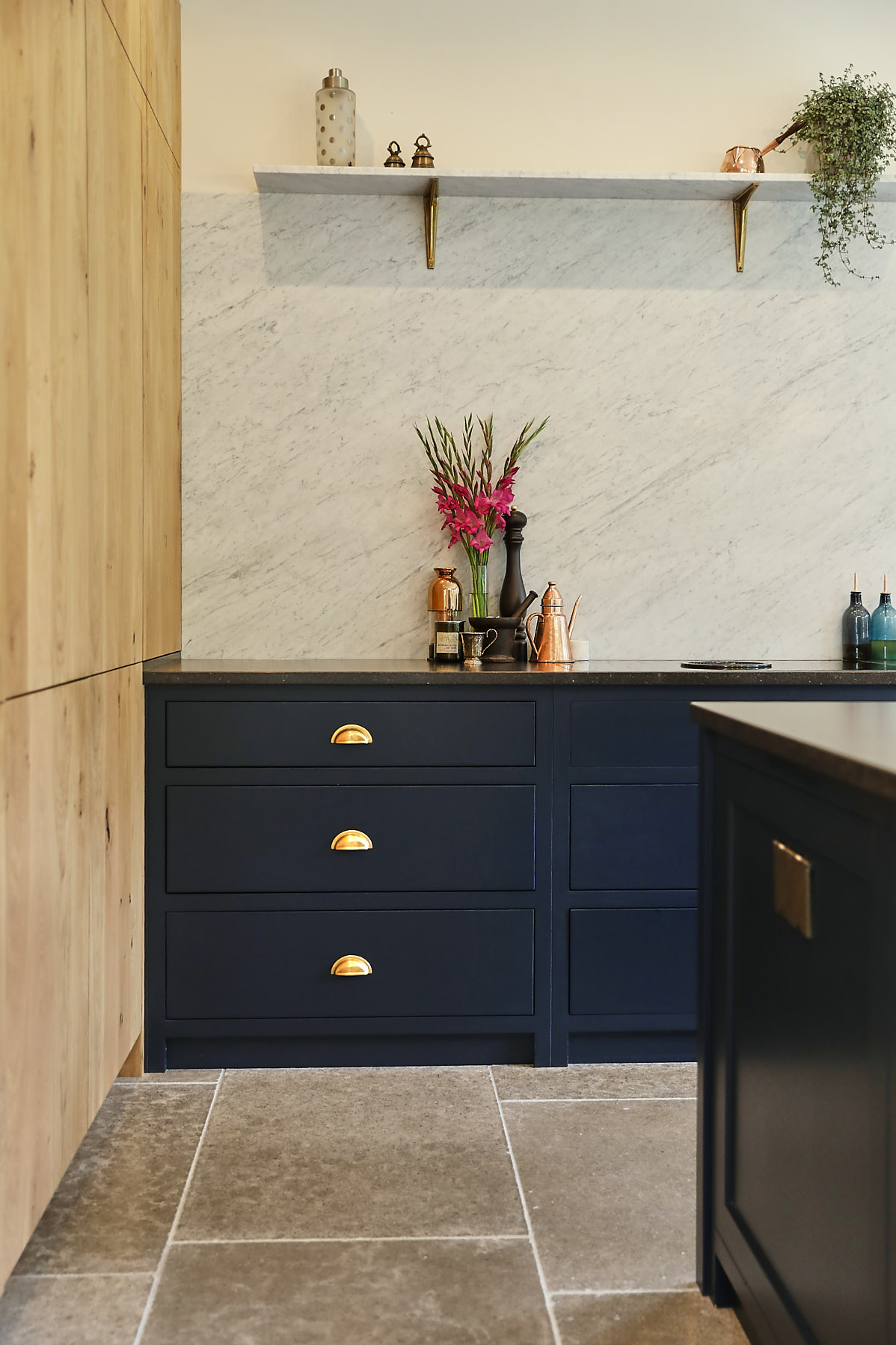 Blue kitchen pan drawers with antique brass cup handles