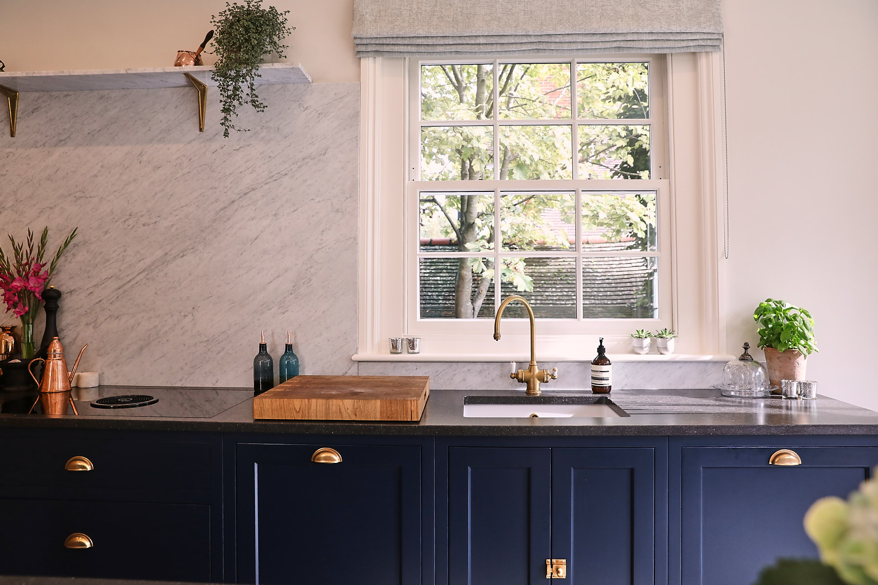 Painted blue kitchen with BORA downdraft and antique brass tap