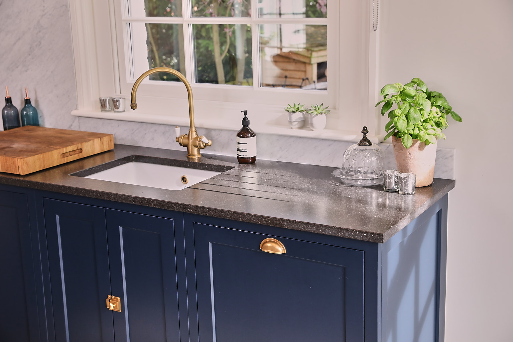 Integrated dishwasher with painted blue in-frame cabinets with antique copper cup handle