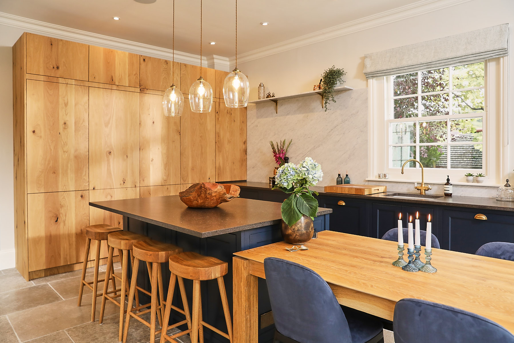 Tall French oak larder in open plan blue kitchen