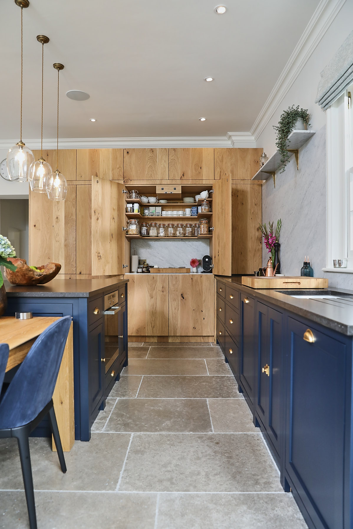 Bespoke kitchen with hidden larder cupboard in tall oak units