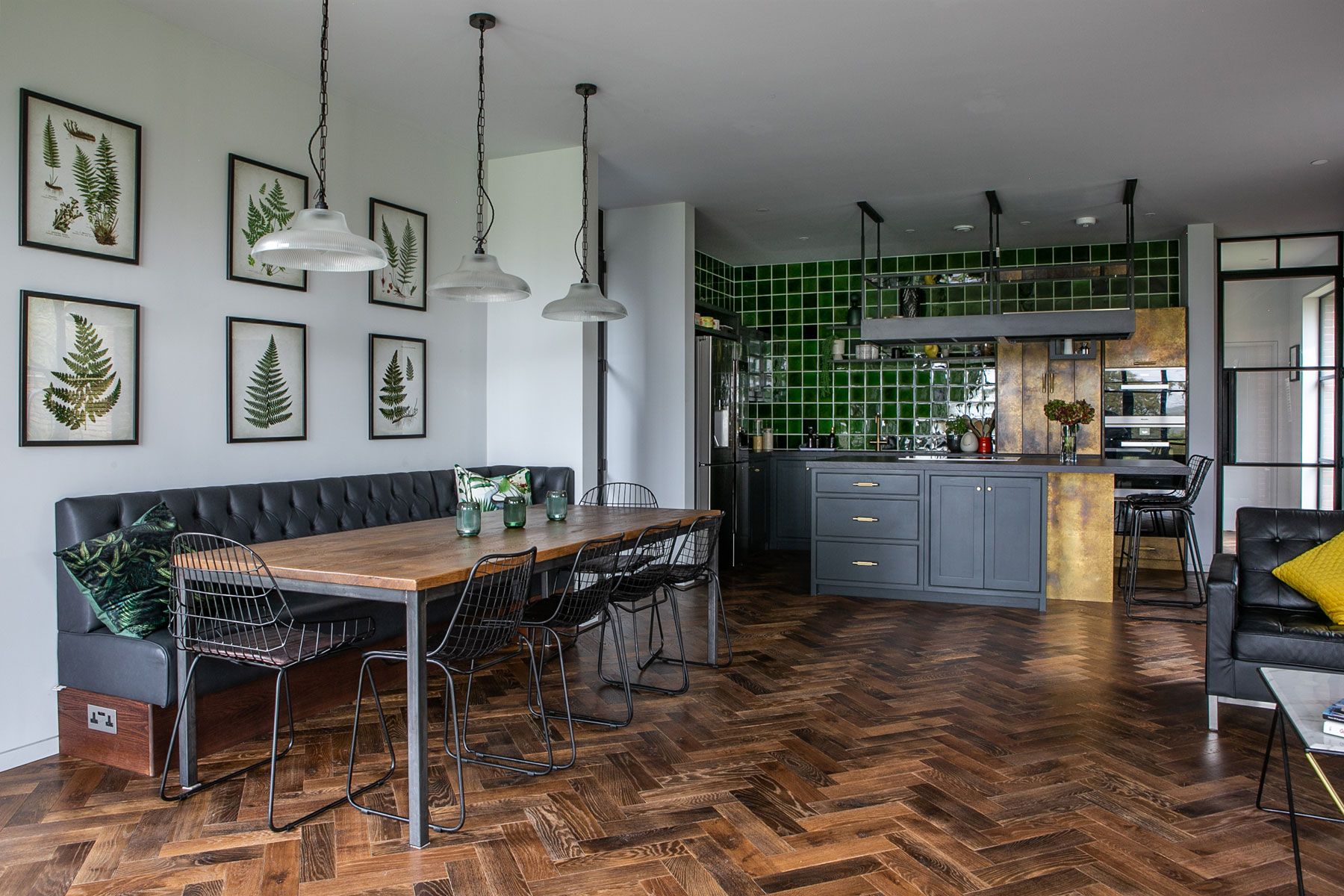 Open plan kitchen diner with parquet wood flooring