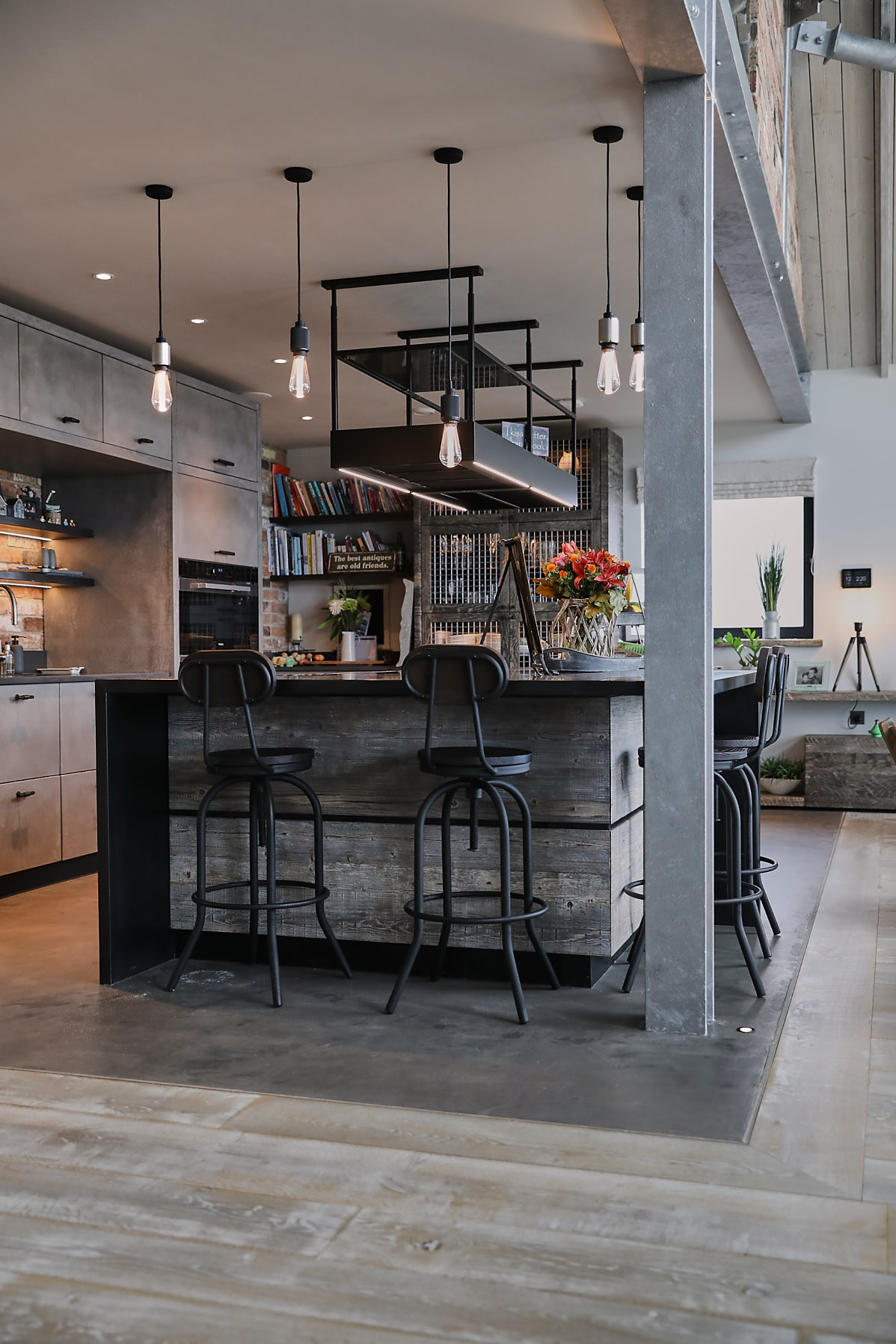 Metal bar stool under reclaimed kitchen island