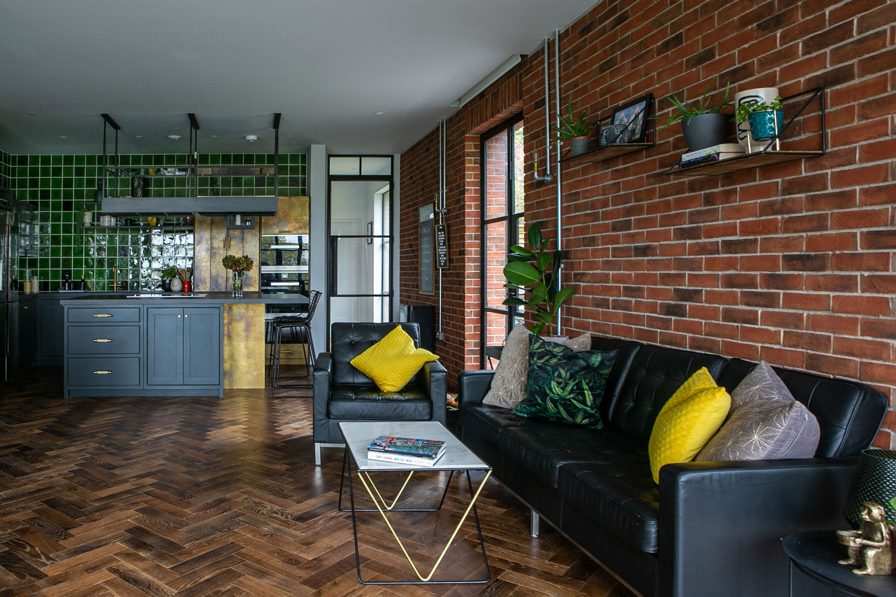 Black leather sofa in open plan kitchen