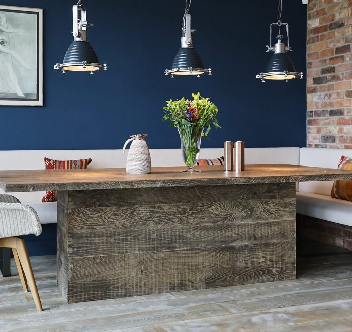 Oak dining table with blue wall