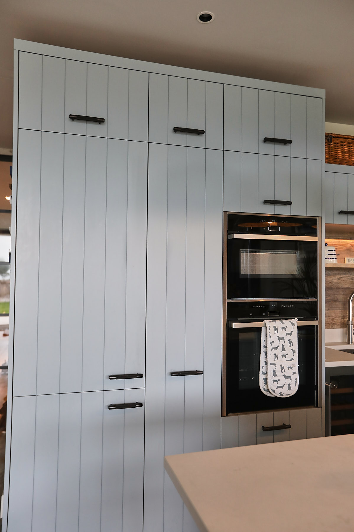 Tall integrated eye level Siemens oven in blue kitchen cabinet