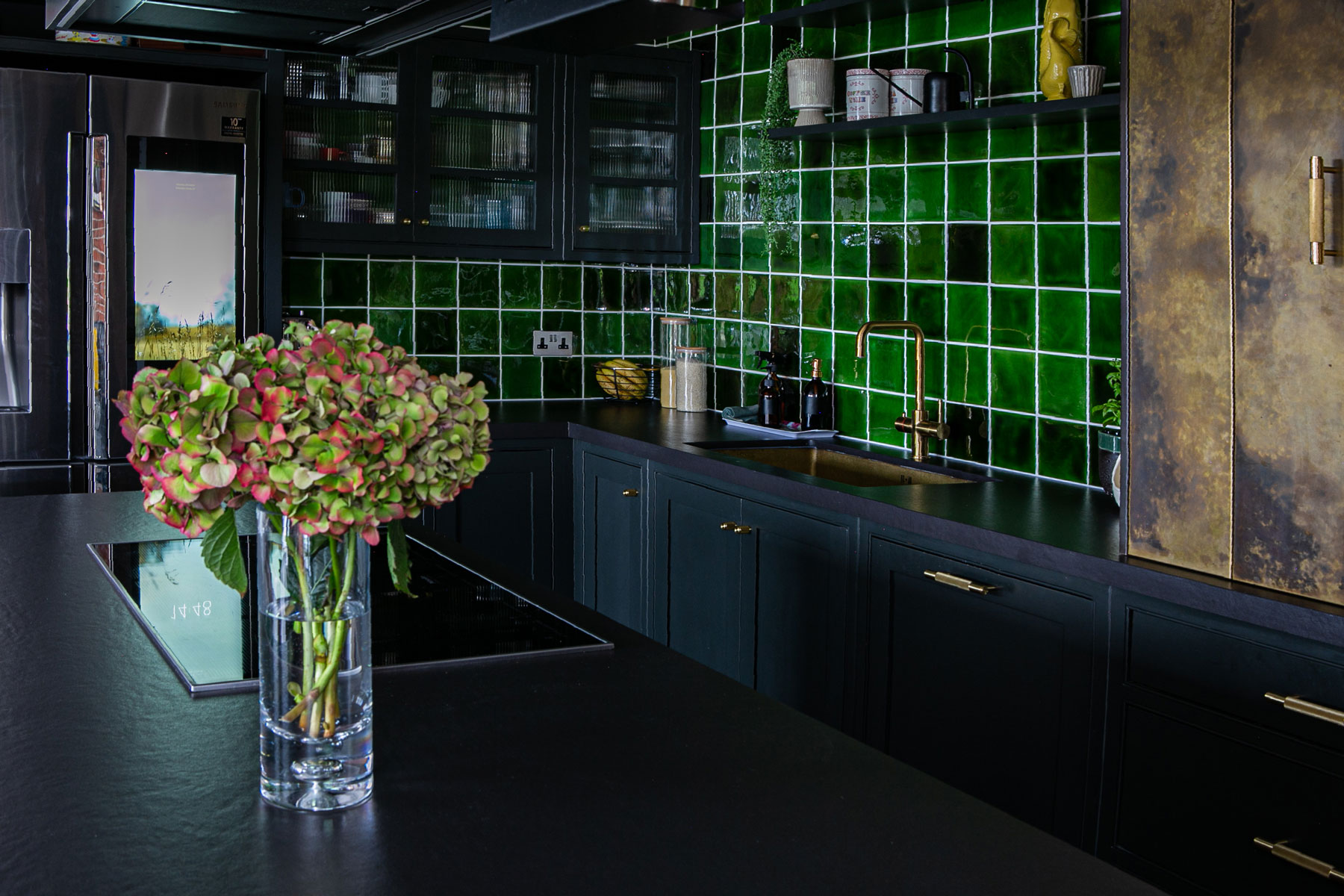 Square green kitchen tiles make large backsplash