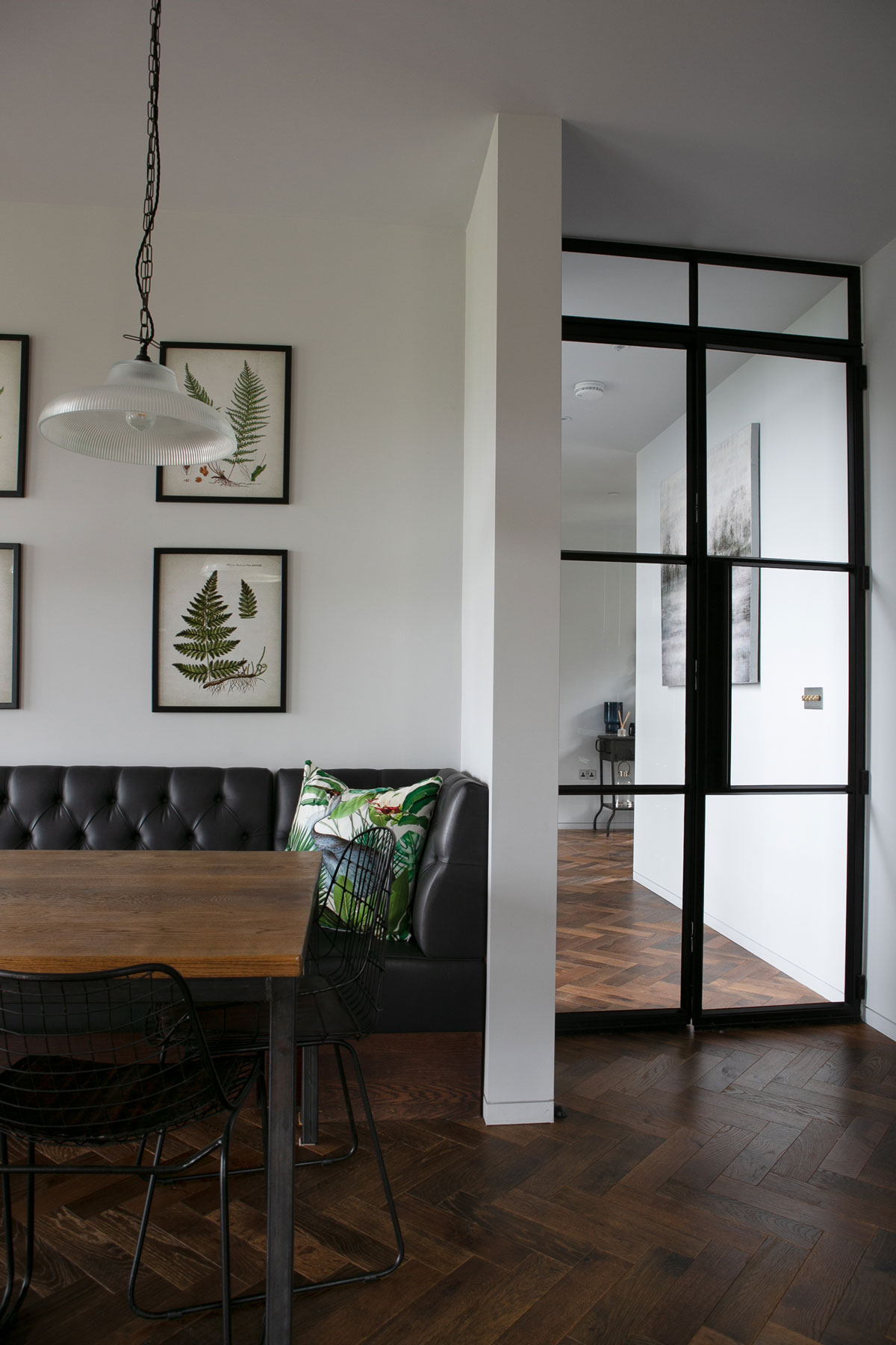 Crittall door in open plan kitchen with parquet flooring