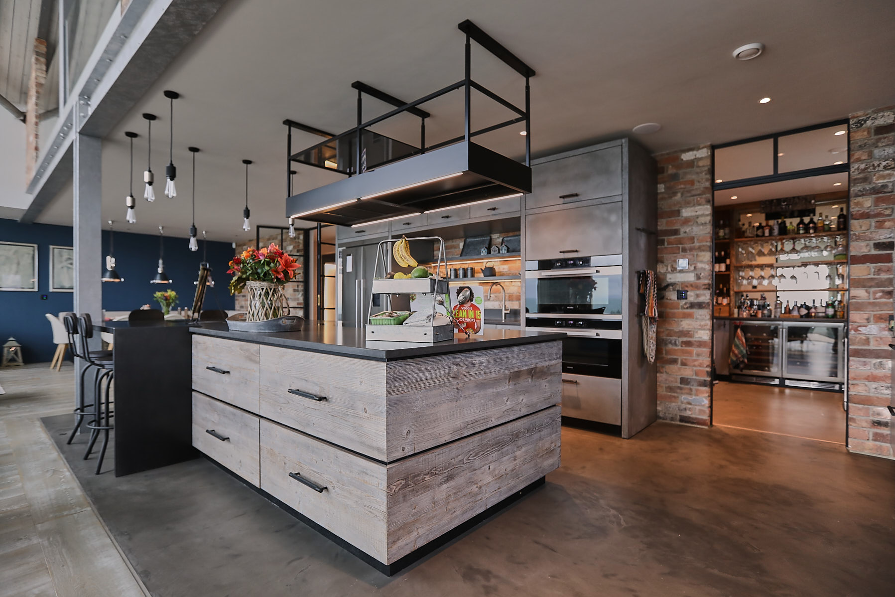 Mixing concrete, zinc and reclaimed wood in bespoke kitchen