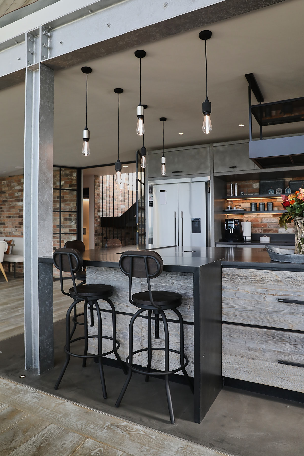 Breakfast bar with metal stools and reclaimed drawers