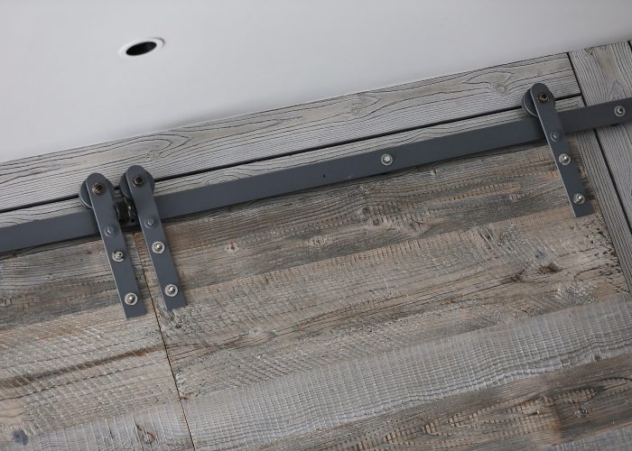 Metal rail for sliding barn doors