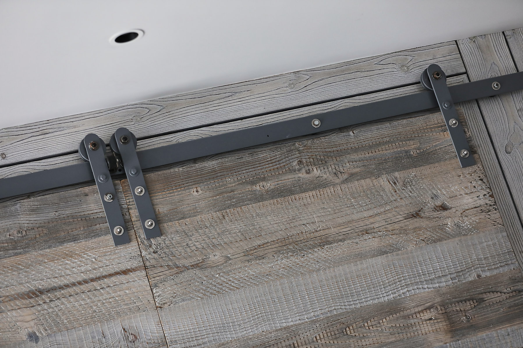 Metal rail for sliding barn doors