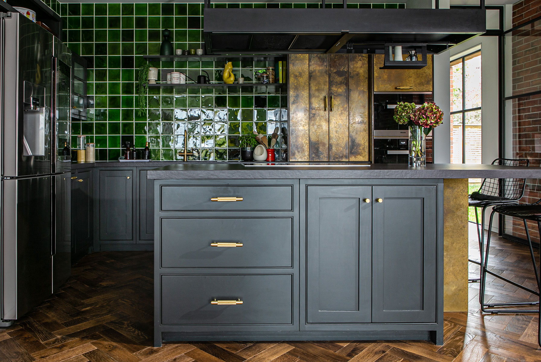 Bespoke kitchen island with painted cabinets and buster punch brass handles