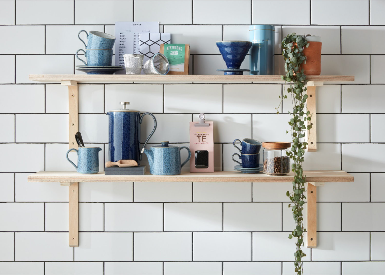 Coffee and mugs on plywood shelves in the kitchen