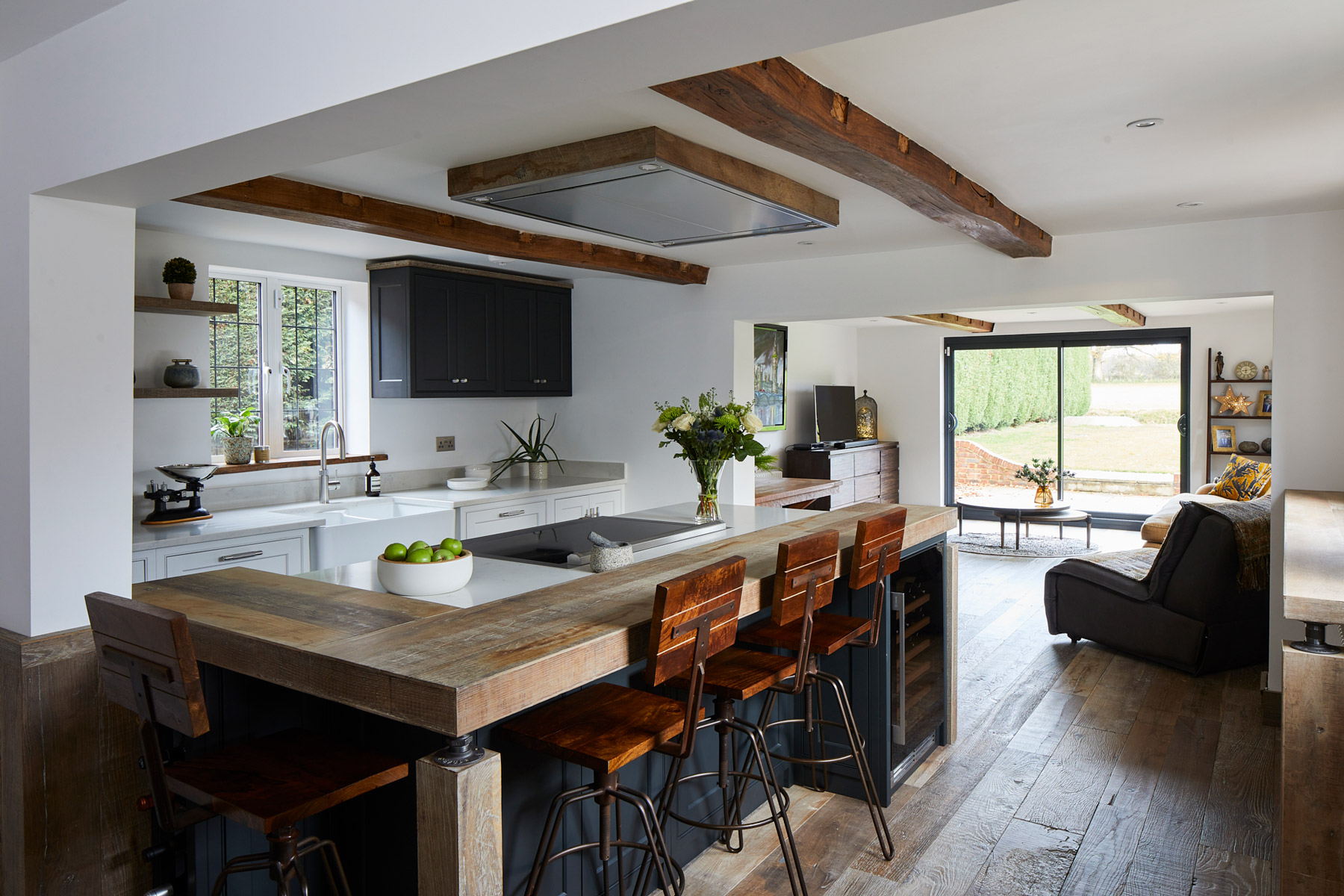 Industrial kitchen with reclaimed oak breakfast bar and painted dark island