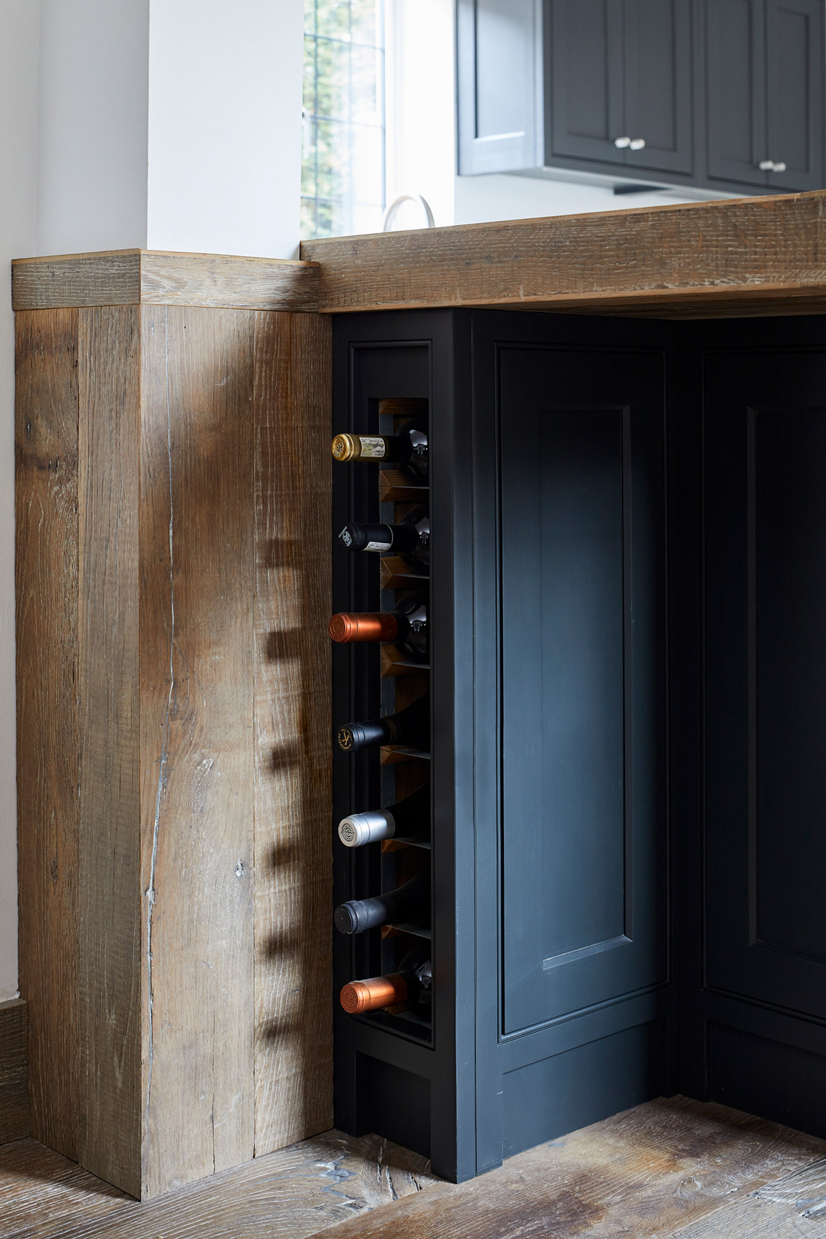 Slim kitchen wine rack in painted cabinets