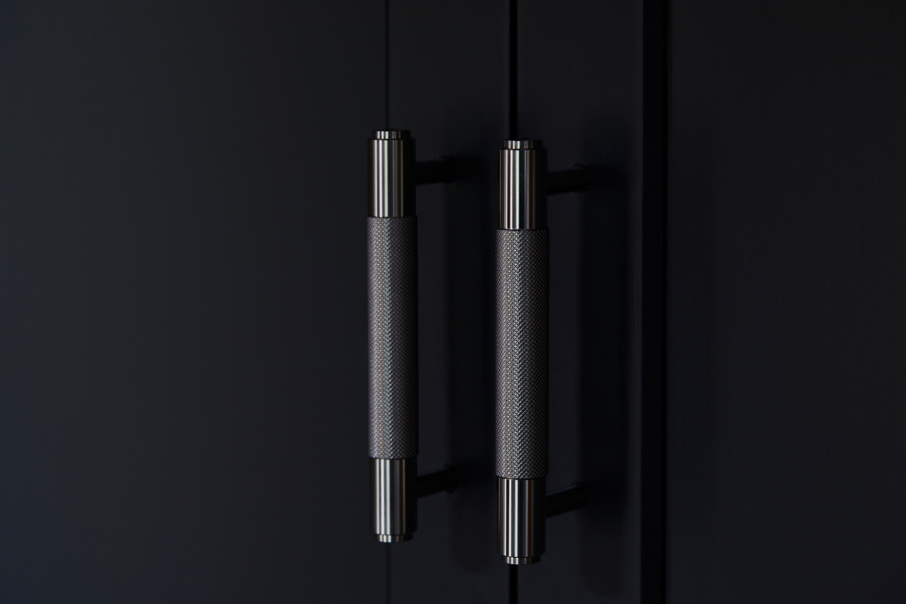 Knurled Buster + Punch brass kitchen handles on painted dark black cabinets
