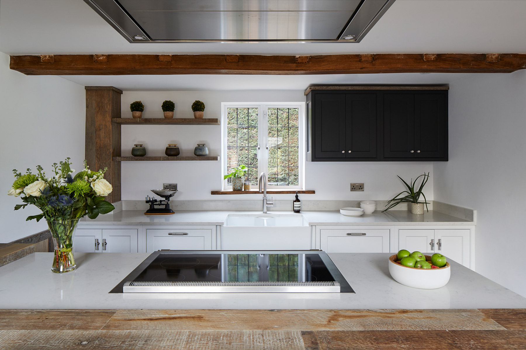 Bespoke painted kitchen with open shelves and dark wall cabinet on sink run