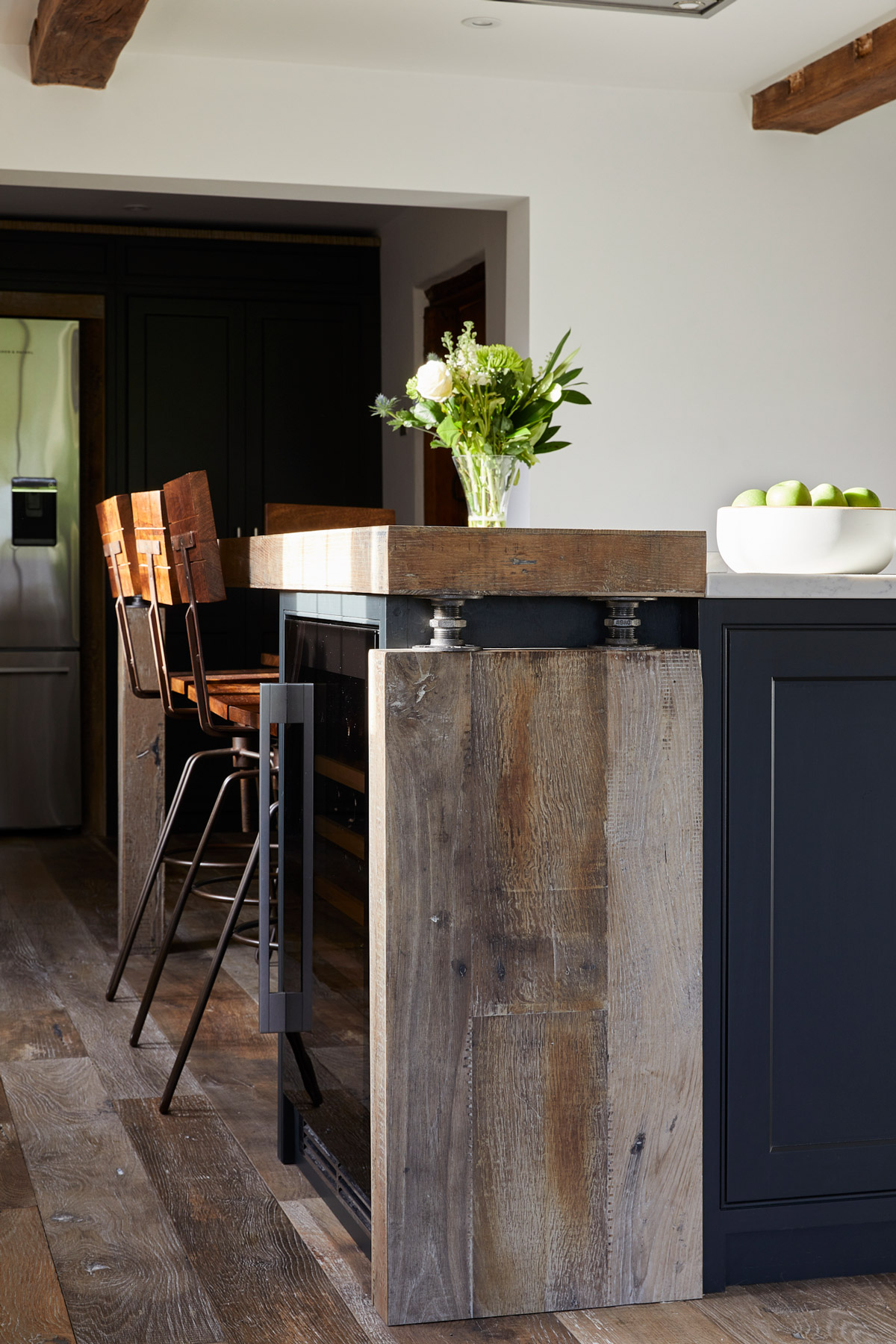 Chunky reclaimed oak kitchen breakfast bar with steel pipes