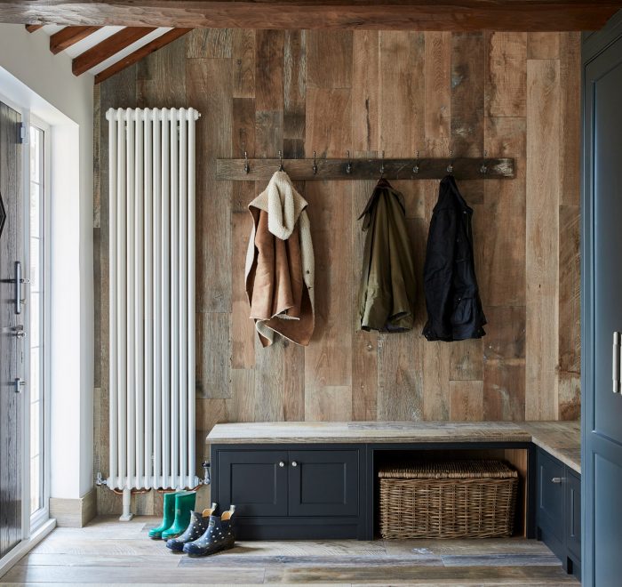 Painted boot room cabinets against reclaimed wall cladding