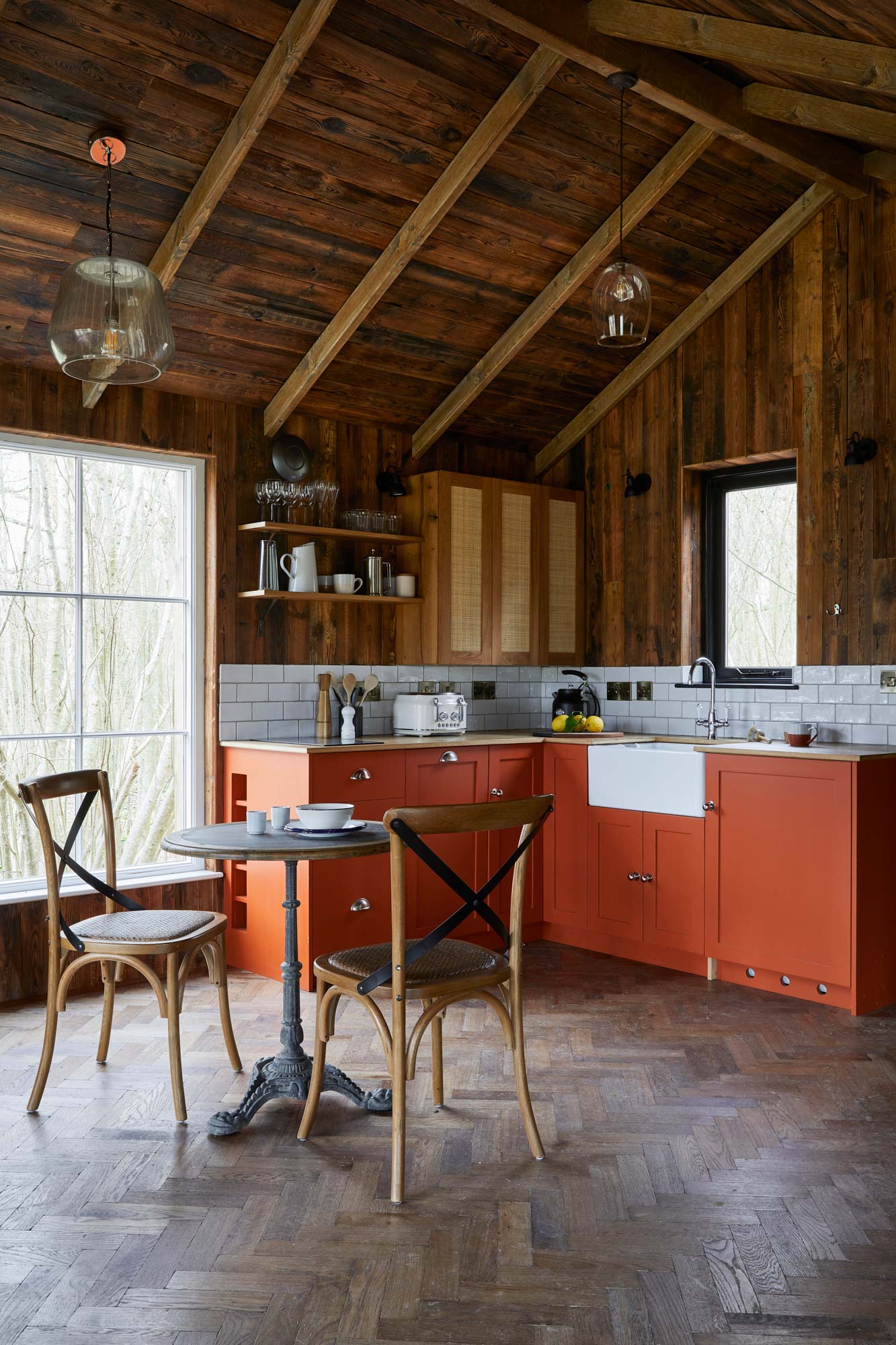 Reclaimed wall cladding against parquet flooring