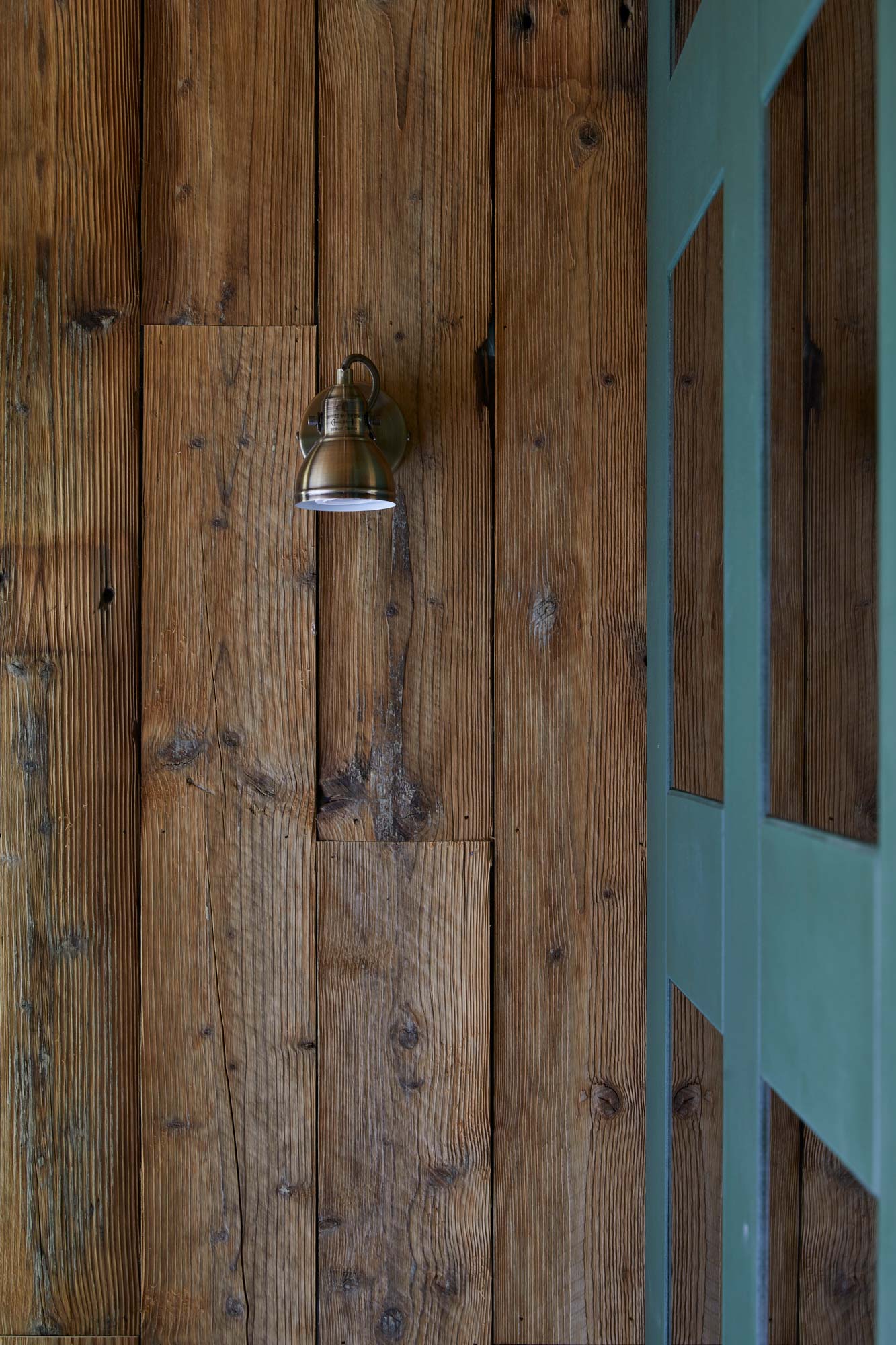 Bedroom spotlight on reclaimed pine cladding