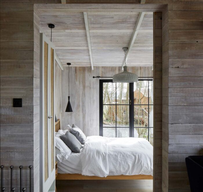 Treehouse bedroom with white cladded walls