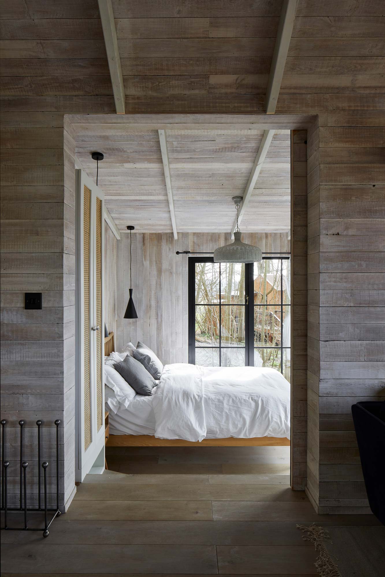 Treehouse bedroom with white cladded walls