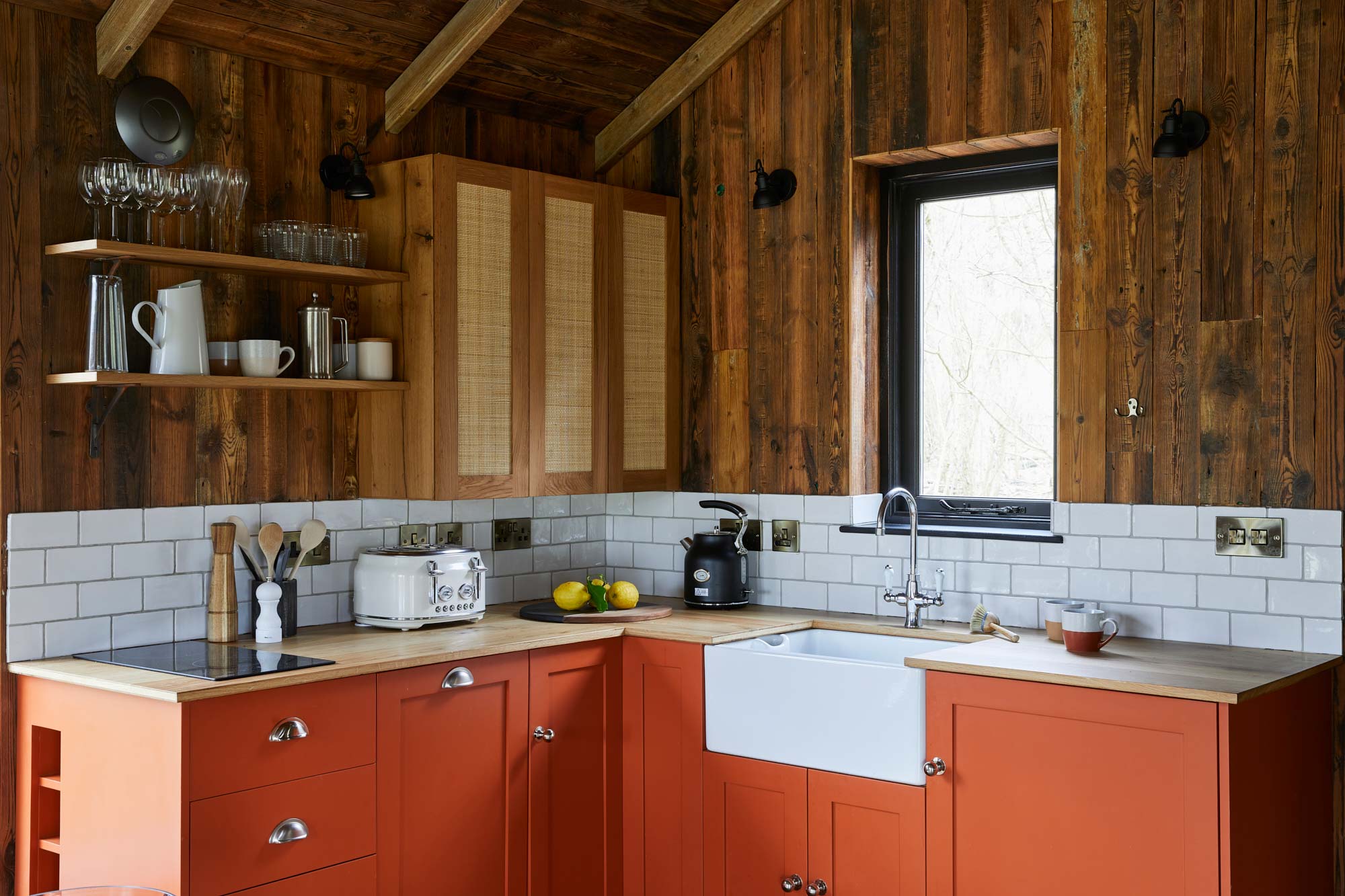 Bespoke orange kitchen in treehouse