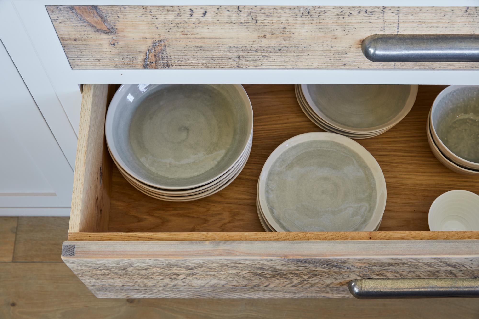 Ceramic bowls and plates in deep kitchen pan drawers