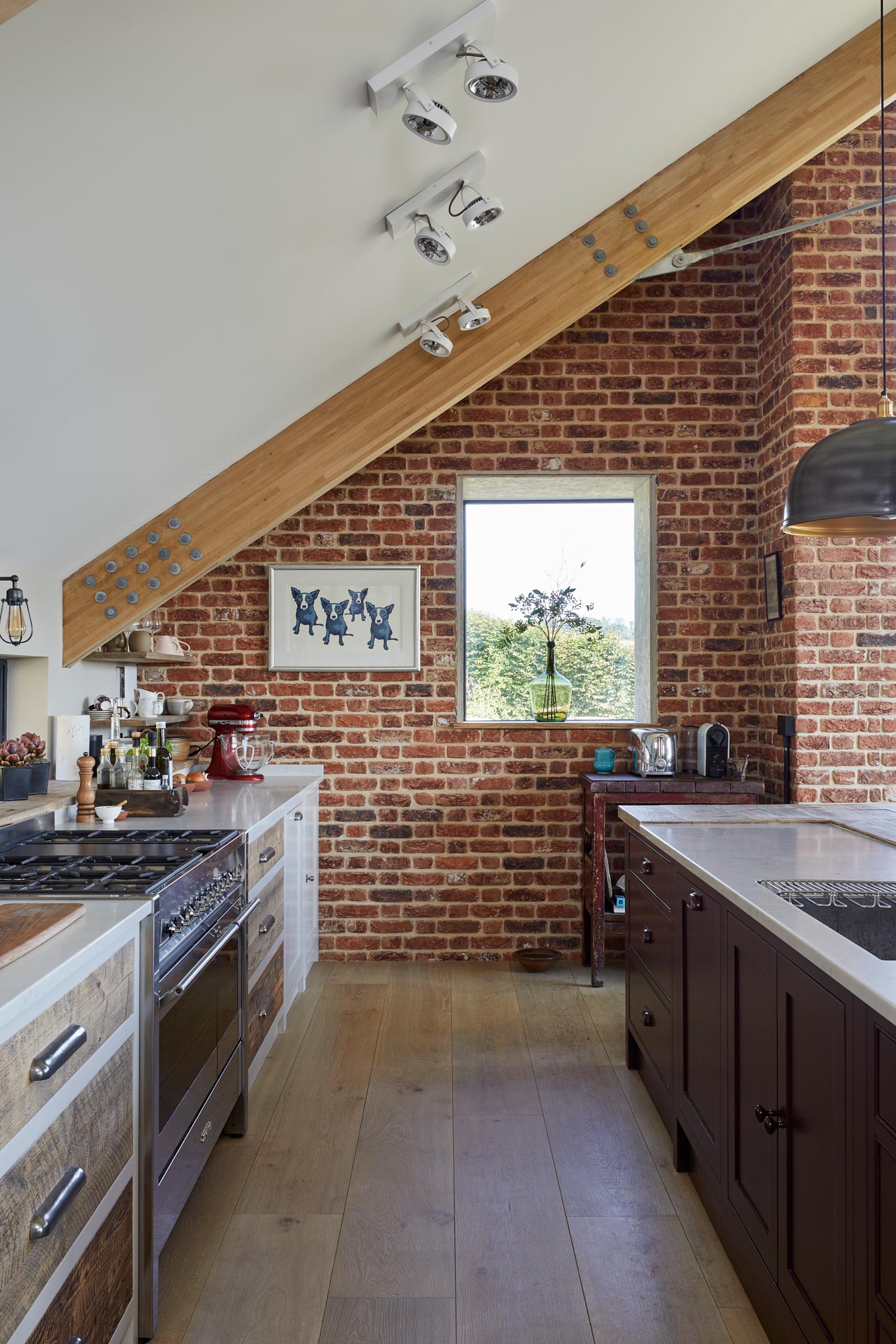 Exposed brick wall in kitchen with clean oak engineered flooring