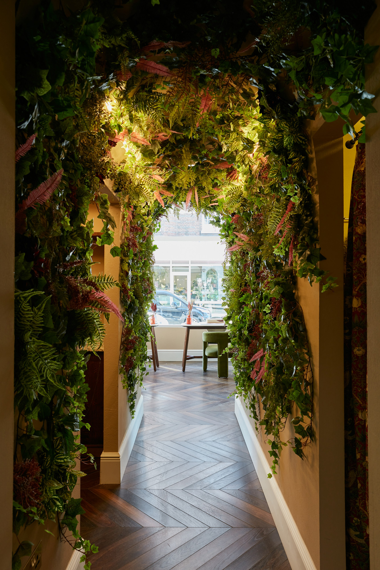 Green plants flow around archway