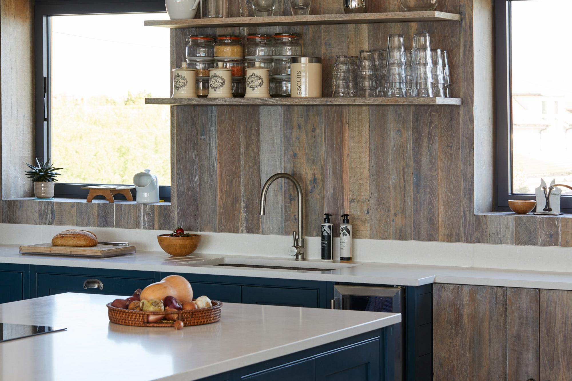 Reclaimed cladded wall behind kitchen sink