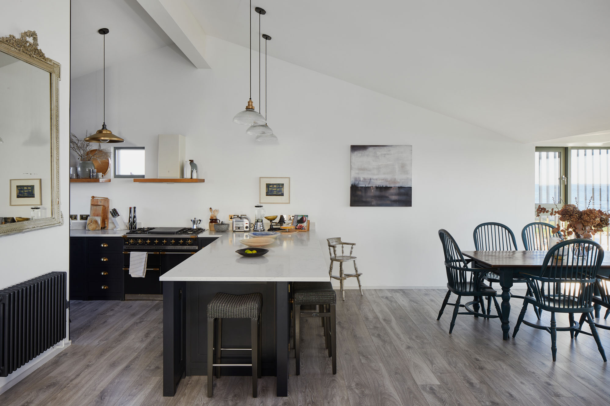 Open plan kitchen painted in deep blue