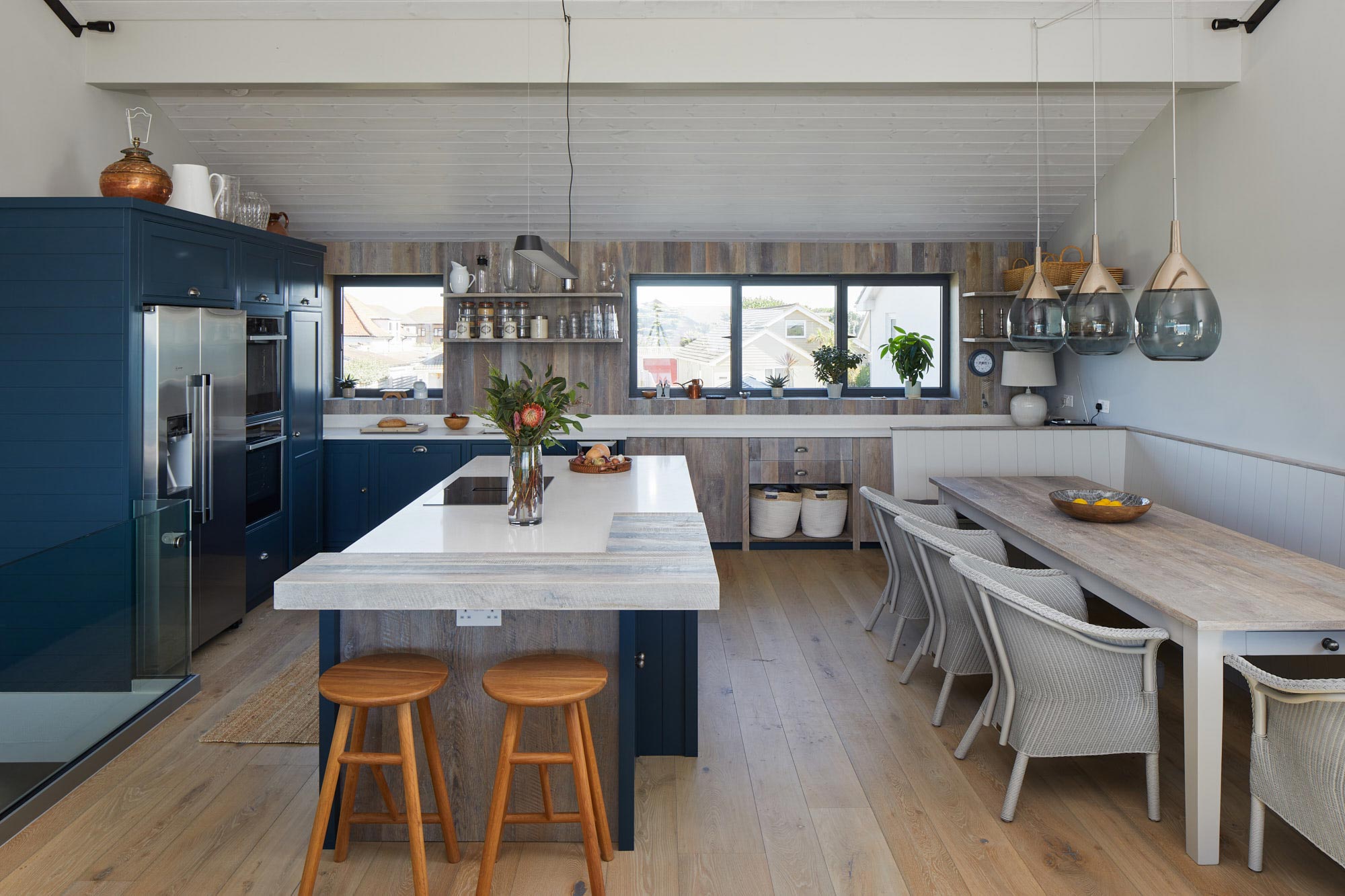 Open plan kitchen cladded in reclaimed timber