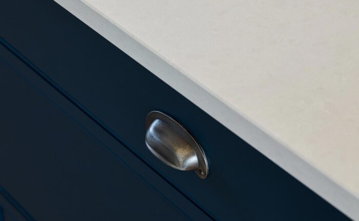 Pewter cup handles on kitchen drawer