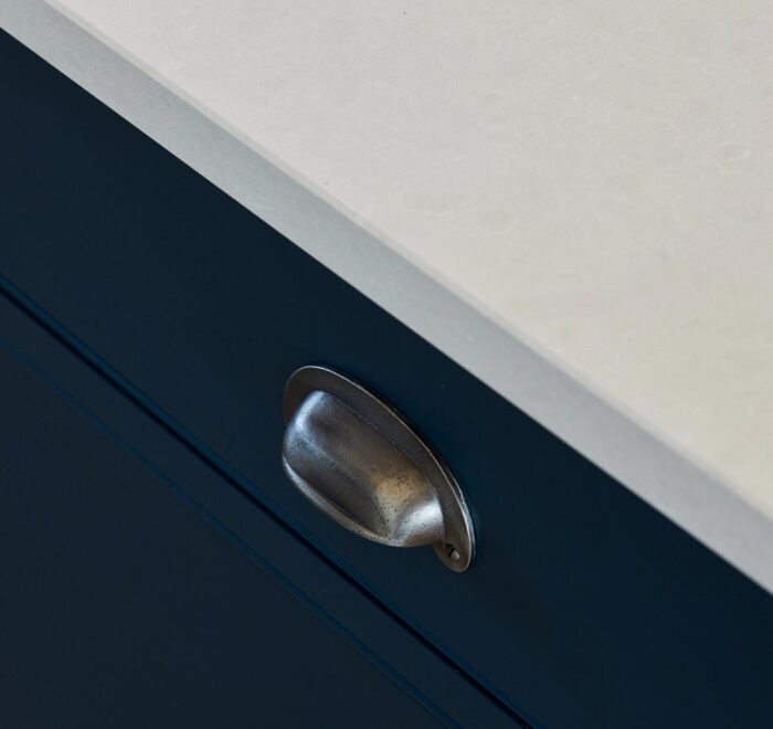 Pewter cup handles on kitchen drawer