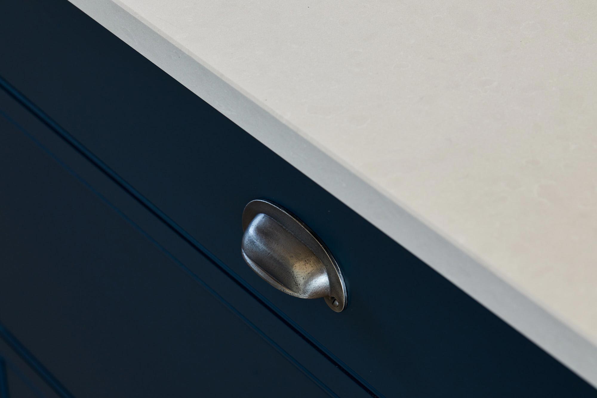 Pewter cup handles on kitchen drawer