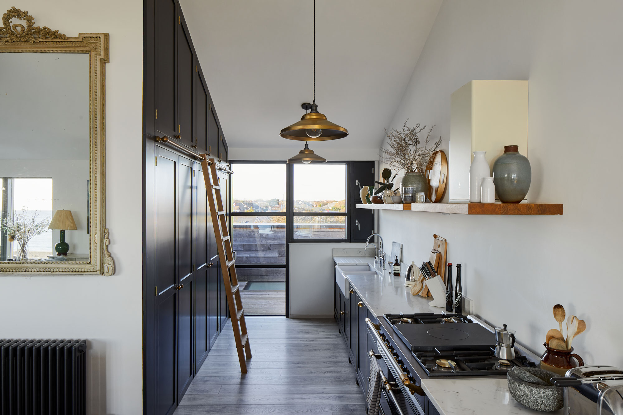 Tall floor to ceiling kitchen cabinets with ladder