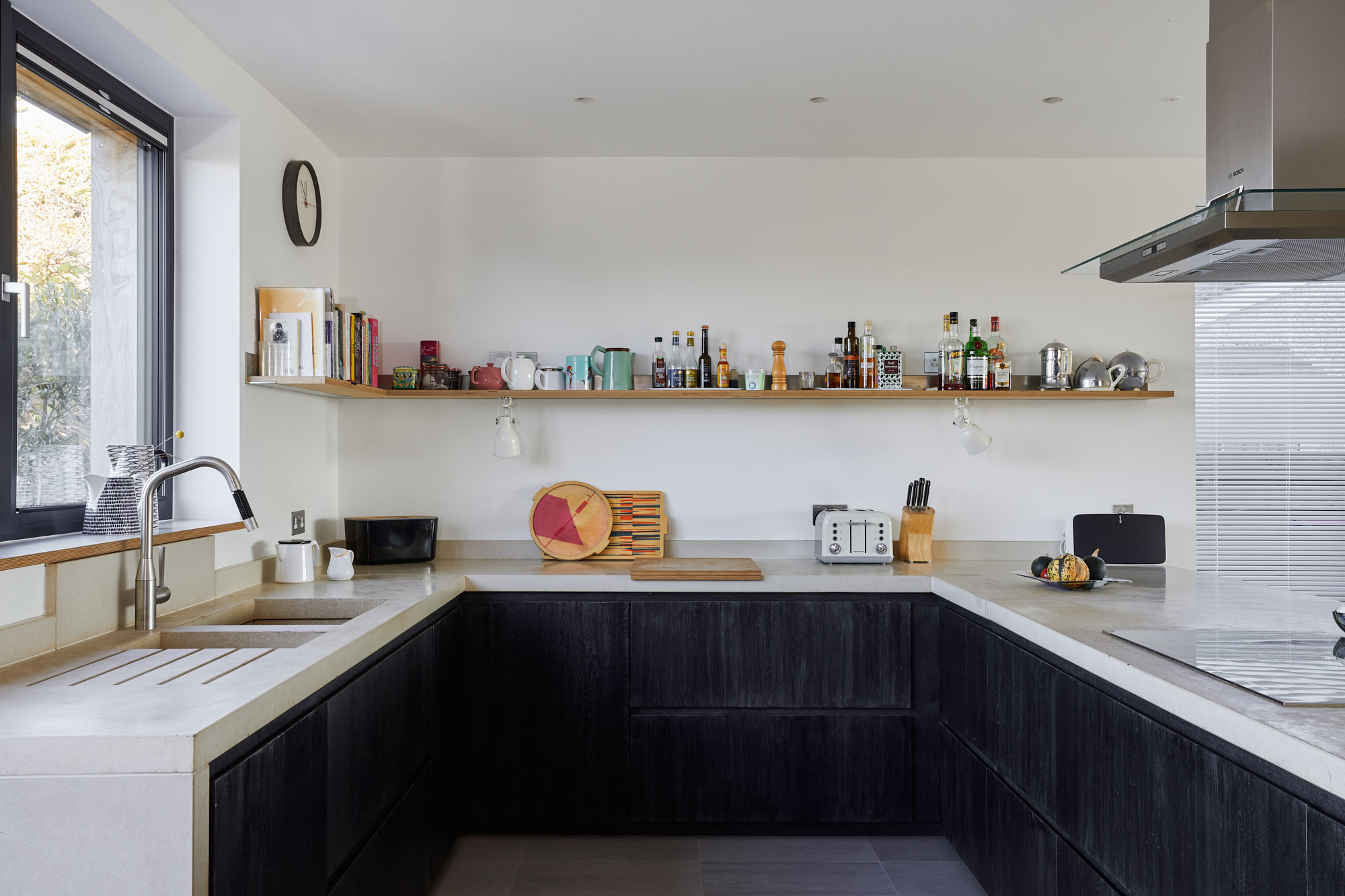 Minimal kitchen design with black washed oak cabinets