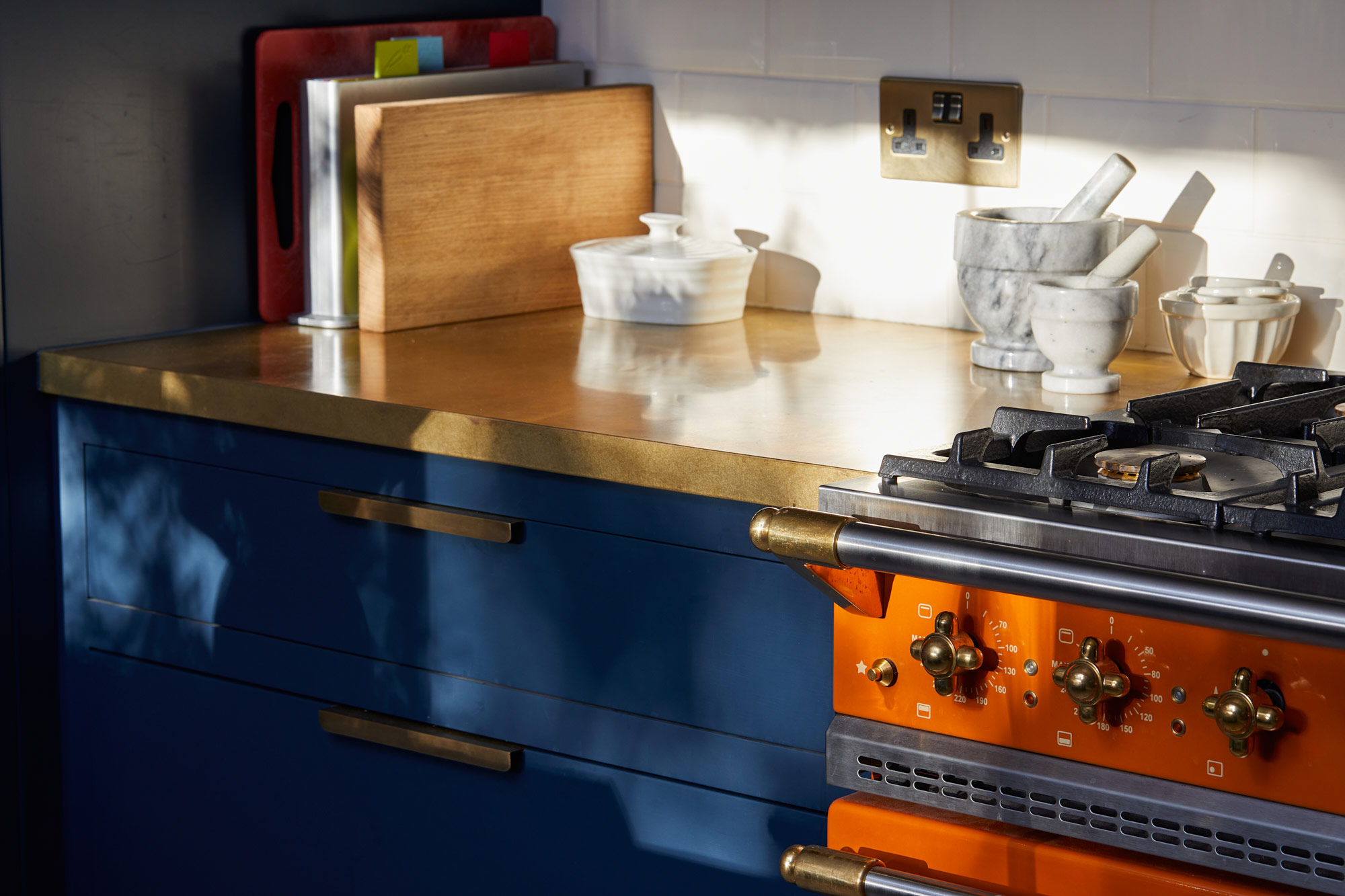 Brass detail on orange Lacanche kitchen cooker