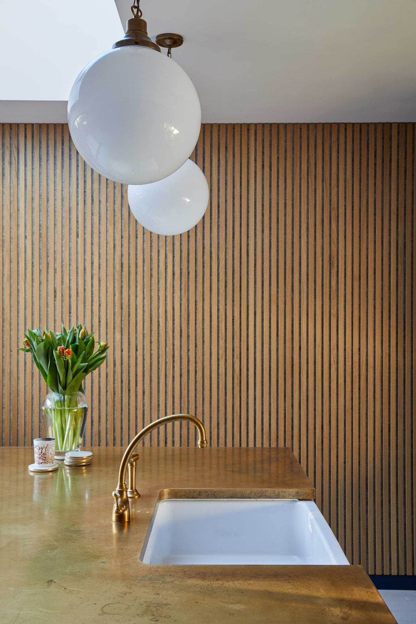 Clean oak cladded feature wall in bespoke kitchen