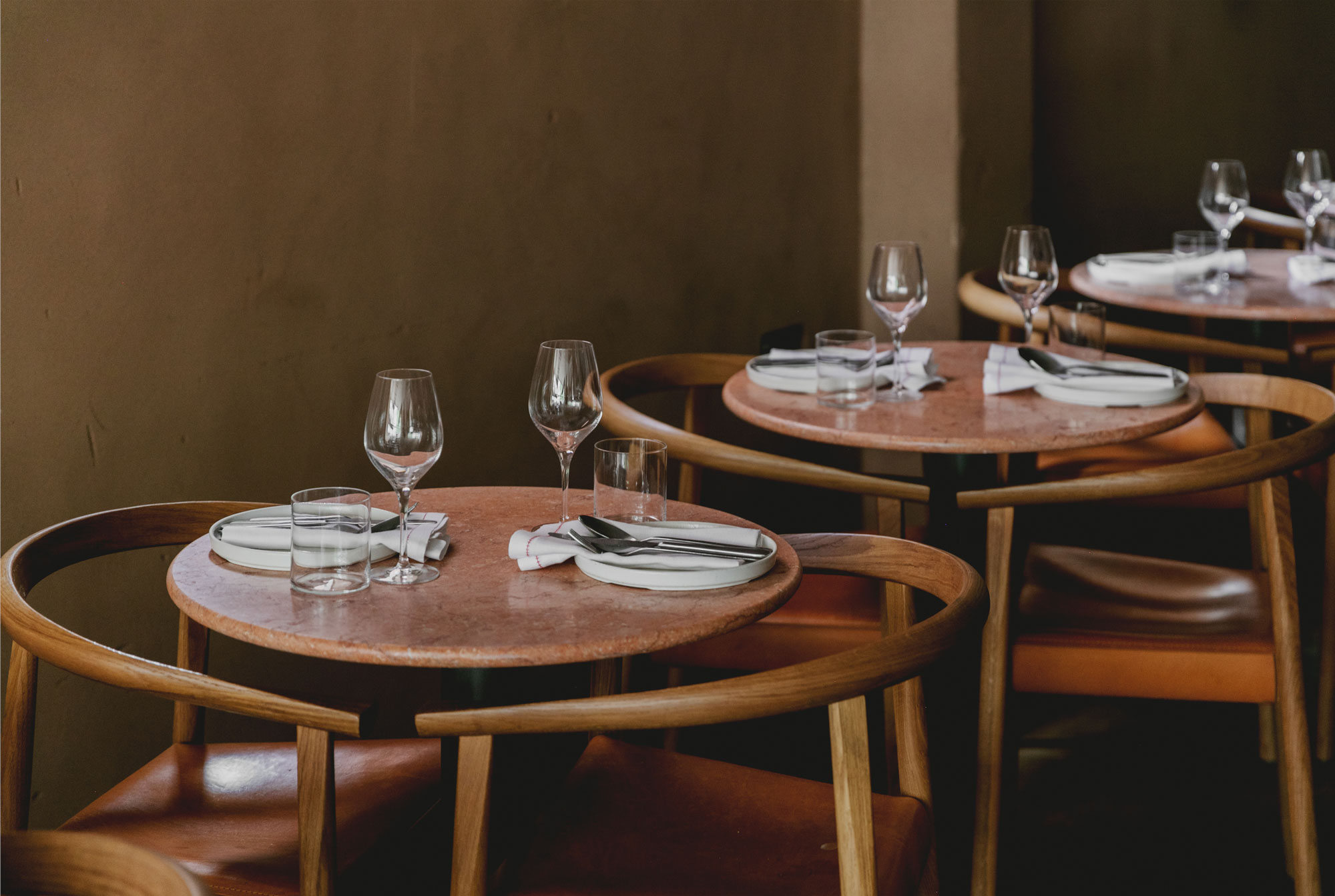 Round oak dining table and chairs in Manteca restaurant