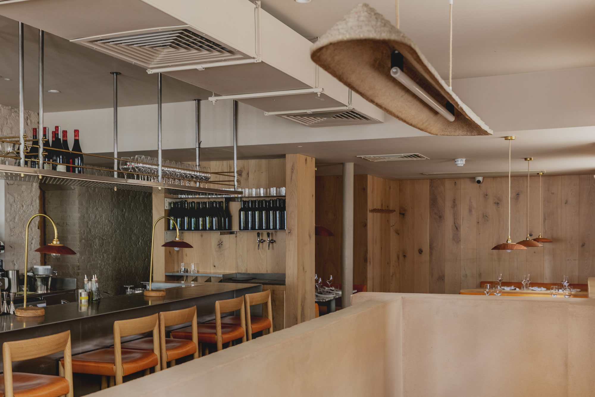 Wooden clad wall in open plan restaurant