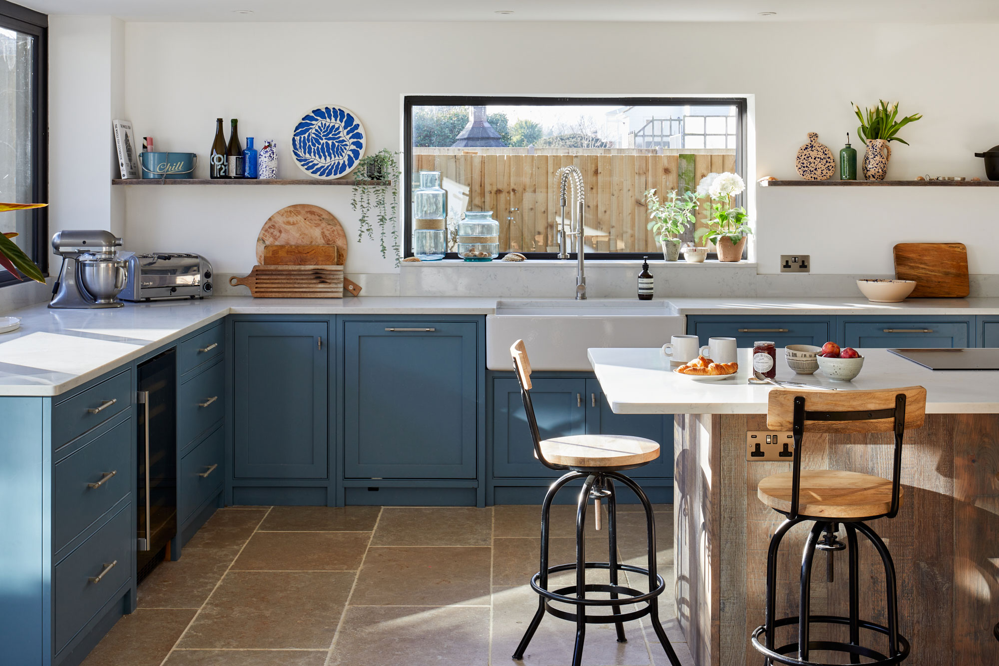 Bespoke kitchen cabinets painted in a teal blue green by Little Greene paint company