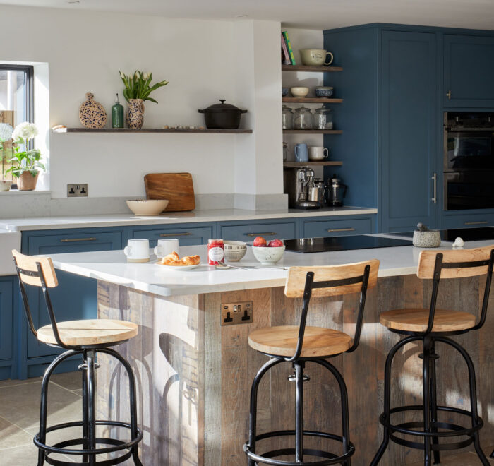 Open plan modern kitchen in Kent mixes reclaimed oak and paint for it's cabinetry