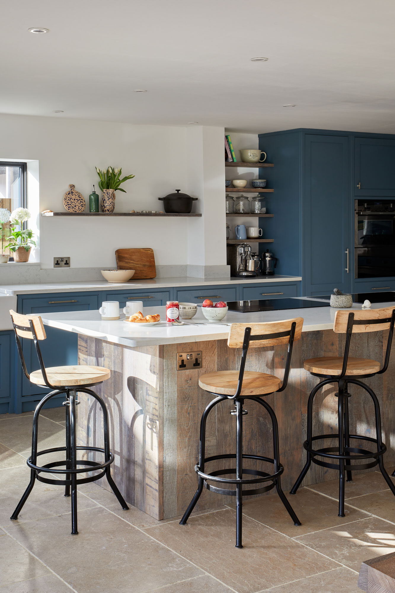 Open plan modern kitchen in Kent mixes reclaimed oak and paint for it's cabinetry
