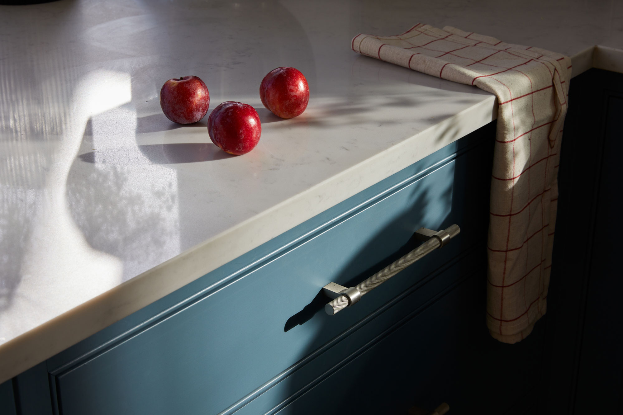 Light shines across this white quartz kitchen worktop